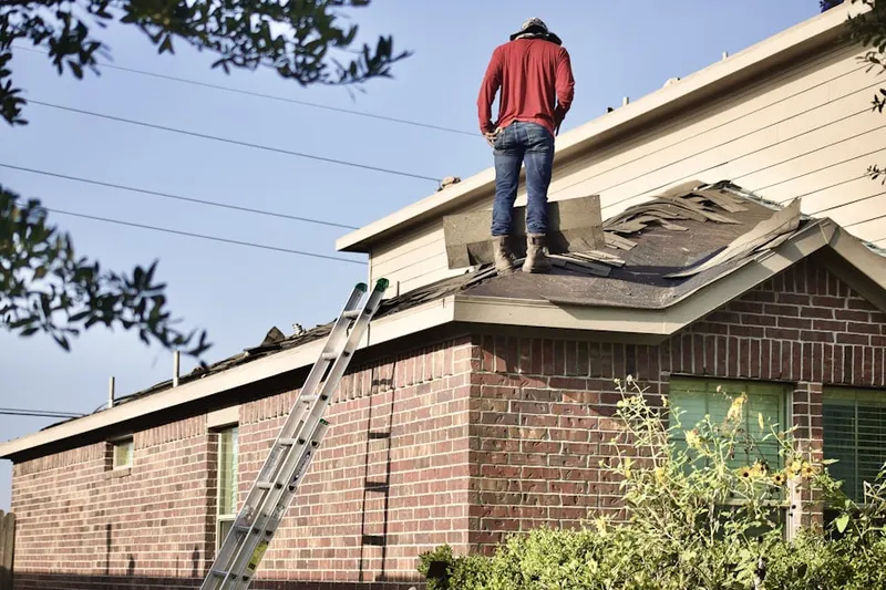 Professional roofer working on a residential roof in New Carrollton